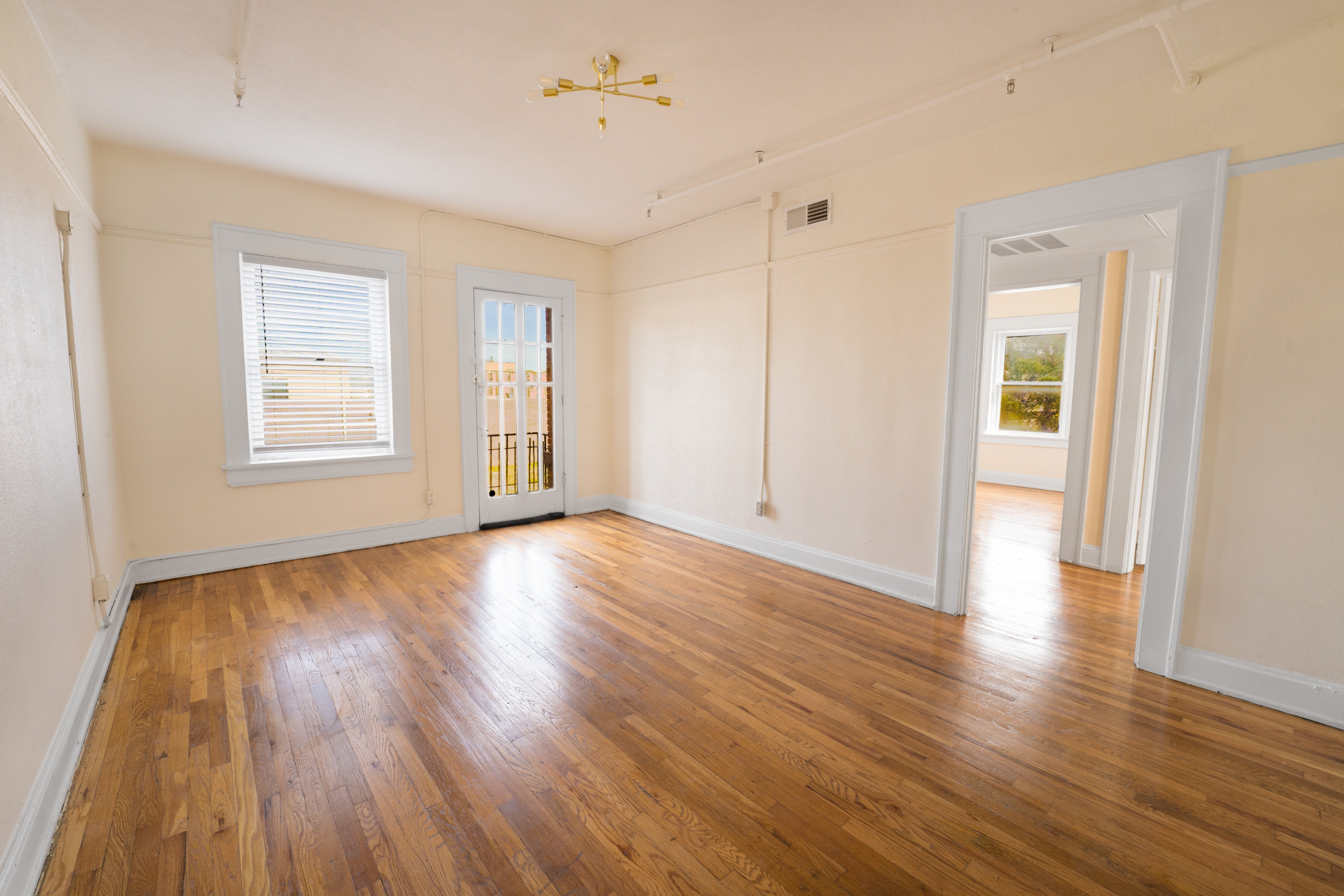 A room with wooden floors and white walls.